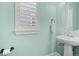 Well lit powder room with contemporary pedestal sink and modern fixtures at 11346 E 27Th Ave, Denver, CO 80238
