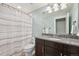 Bathroom featuring a granite vanity and shower with a patterned shower curtain at 11346 E 27Th Ave, Denver, CO 80238