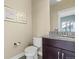 Elegant half bathroom with a granite countertop and framed art at 11346 E 27Th Ave, Denver, CO 80238