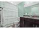 Bathroom with tile floors, granite counter, and shower with striped curtain at 11346 E 27Th Ave, Denver, CO 80238