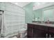 Bathroom featuring a vanity with granite countertop and a shower with a striped shower curtain at 11346 E 27Th Ave, Denver, CO 80238