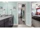 Bathroom featuring granite countertop, vanity, walk-in closet, and bedroom access at 11346 E 27Th Ave, Denver, CO 80238