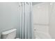 Clean bathroom featuring a shower/tub with white tile and a shower curtain, creating a functional space at 11346 E 27Th Ave, Denver, CO 80238