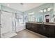 Luxurious bathroom with a soaking tub, glass-enclosed shower, and double vanity with granite countertops at 11346 E 27Th Ave, Denver, CO 80238
