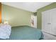 Cozy bedroom showcases soft green walls and a view of the staircase at 11346 E 27Th Ave, Denver, CO 80238