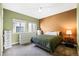 Cozy bedroom with dual windows and a restful green and brown color scheme at 11346 E 27Th Ave, Denver, CO 80238