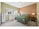 Relaxing bedroom with light green and peach walls, and featuring an inviting bed and bright natural light at 11346 E 27Th Ave, Denver, CO 80238