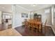Elegant dining room with wood floors, a large wooden table, and a decorative cabinet at 11346 E 27Th Ave, Denver, CO 80238
