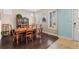 Traditional dining room featuring a wood table, chairs, hutch and natural light from shuttered windows at 11346 E 27Th Ave, Denver, CO 80238