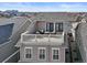 Aerial view of a home featuring a rooftop deck with outdoor seating and a fire pit at 11346 E 27Th Ave, Denver, CO 80238