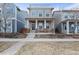 Inviting two-story home featuring a welcoming front porch with seating and well-maintained landscaping at 11346 E 27Th Ave, Denver, CO 80238