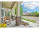 Charming covered front porch with brick pillars, offering a relaxing outdoor seating area at 11346 E 27Th Ave, Denver, CO 80238