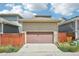 Detached garage with a pink garage door and wooden privacy fence at 11346 E 27Th Ave, Denver, CO 80238