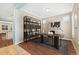 Bright home office featuring built-in shelving, a modern desk, and hardwood floors at 11346 E 27Th Ave, Denver, CO 80238