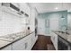 Modern kitchen with subway tile backsplash, granite countertops, and stainless steel appliances at 11346 E 27Th Ave, Denver, CO 80238