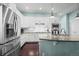 Modern kitchen features stainless steel appliances, white cabinetry, and an open layout at 11346 E 27Th Ave, Denver, CO 80238