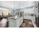 Modern, open kitchen features a large island, stainless steel appliances, and hardwood floors at 11346 E 27Th Ave, Denver, CO 80238