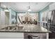Open kitchen with granite countertops, stainless steel appliances, and breakfast bar at 11346 E 27Th Ave, Denver, CO 80238