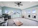Spacious living room with large windows, neutral colors, and access to an outdoor deck at 11346 E 27Th Ave, Denver, CO 80238