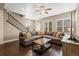 Spacious living room with hardwood floors, a comfortable sectional sofa, and natural light at 11346 E 27Th Ave, Denver, CO 80238
