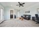 Spacious living room with a sofa, desk and a peek into an attached bathroom at 11346 E 27Th Ave, Denver, CO 80238