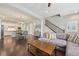 Open concept living space adjacent to the kitchen with hardwood flooring, stairs and lots of natural light at 11346 E 27Th Ave, Denver, CO 80238