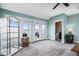 Spacious living room boasts light blue walls and access to an outdoor seating area at 11346 E 27Th Ave, Denver, CO 80238