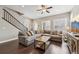Bright living room with comfortable seating, hardwood floors, and lots of natural light from shuttered windows at 11346 E 27Th Ave, Denver, CO 80238