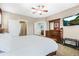 Comfortable main bedroom with a large bed, wood furniture, and an en-suite bathroom at 11346 E 27Th Ave, Denver, CO 80238