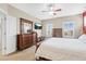 Bright main bedroom with hardwood furniture, a ceiling fan, and plenty of natural light at 11346 E 27Th Ave, Denver, CO 80238