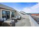 Relaxing rooftop deck features comfortable seating and a cozy fire pit to enjoy the stunning city views at 11346 E 27Th Ave, Denver, CO 80238