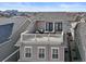 Aerial view of rooftop patio with outdoor furniture, overlooking cityscape and neighboring houses at 11346 E 27Th Ave, Denver, CO 80238