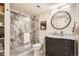 Updated bathroom featuring a marble shower, modern vanity, and stylish round mirror at 2650 Hawthorne Pl, Boulder, CO 80304