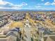Aerial view of a suburban community featuring a park with walking paths and various style homes at 1950 W 67Th Ave, Denver, CO 80221