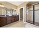 Bathroom with double sink vanity, granite countertop, tile floor and glass shower at 1950 W 67Th Ave, Denver, CO 80221