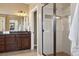 Modern bathroom boasts a double vanity with granite countertop and glass enclosed shower at 1950 W 67Th Ave, Denver, CO 80221