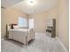 Comfortable bedroom featuring neutral walls and carpet, a bed, and an open cabinet at 1950 W 67Th Ave, Denver, CO 80221