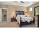 Spacious bedroom featuring an ornate dark wood bed frame and neutral carpeting at 1950 W 67Th Ave, Denver, CO 80221
