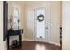 Bright entryway with wood floors, frosted glass door and decorative table at 1950 W 67Th Ave, Denver, CO 80221