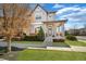 Charming two-story home featuring a covered front porch, a landscaped lawn, and a welcoming entryway at 1950 W 67Th Ave, Denver, CO 80221