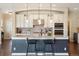 Bright open-concept kitchen island with pendant lighting and modern appliances at 1950 W 67Th Ave, Denver, CO 80221