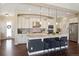 Spacious kitchen featuring a large island with seating, stainless steel appliances, and modern lighting at 1950 W 67Th Ave, Denver, CO 80221