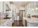 Spacious kitchen featuring stainless steel appliances, granite countertops and white cabinets at 1950 W 67Th Ave, Denver, CO 80221