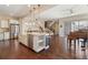 Open concept kitchen with a large island, hardwood floors, and stainless steel appliances at 1950 W 67Th Ave, Denver, CO 80221