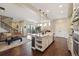 Open-concept kitchen with a large island, stainless steel appliances, and hardwood floors at 1950 W 67Th Ave, Denver, CO 80221