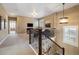 Upstairs landing boasts wood and metal banister, media console, and comfortable seating at 1950 W 67Th Ave, Denver, CO 80221