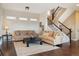 Cozy living room with plush sofas, patterned rug, and staircase access at 1950 W 67Th Ave, Denver, CO 80221