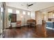 Bright living area with a large window, hardwood floors and a baby grand piano at 1950 W 67Th Ave, Denver, CO 80221