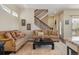 Comfortable living room with sofas, area rug, and decorative pillows by the staircase at 1950 W 67Th Ave, Denver, CO 80221