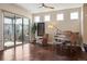 Bright living area with a large window, hardwood floors and a baby grand piano at 1950 W 67Th Ave, Denver, CO 80221